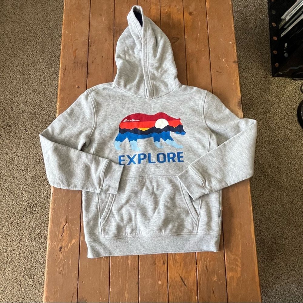 Eddie Bauer youth gray fleece hoodie with a bear and "Explore" graphic
